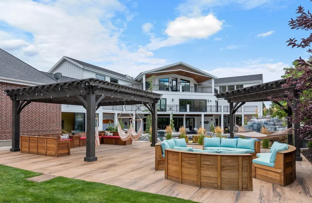 1263 East Chapman Court Home in Alpine, Utah. Step into the lap of luxury in this expansive 13,000 sq ft home in Alpine, Utah. With 8 oversized bedrooms, 6 bathrooms, a 13-car garage, and an outdoor entertainment paradise featuring a pool, spa, and lush landscaping, this property is perfect for hosting and living in grand style.