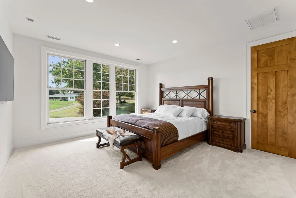13500 Cabarrus Station Road Home in Midland, North Carolina. Experience the epitome of country living at Clover Lake, an architecturally designed estate on over 30 acres of rolling pastures, serene ponds, and private outdoor spaces just 35 minutes from Uptown Charlotte. This exceptional property features a 3-car garage, gated entry, gourmet kitchen, spacious bedrooms with en-suite baths, and a 4-stall horse barn with a shop, tack room, and office.