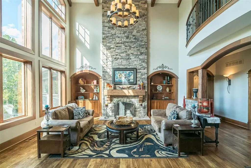 1377 South Mason Road Home in Saint Louis, Missouri. Discover this remarkable 3.3-acre estate bordering Queeny Park, boasting an array of extraordinary outdoor amenities and unmatched privacy. With a massive 2-story foyer, designer kitchen, primary suite with a see-through fireplace, and a sprawling lower level featuring a rec room, theatre, gym, and more. 