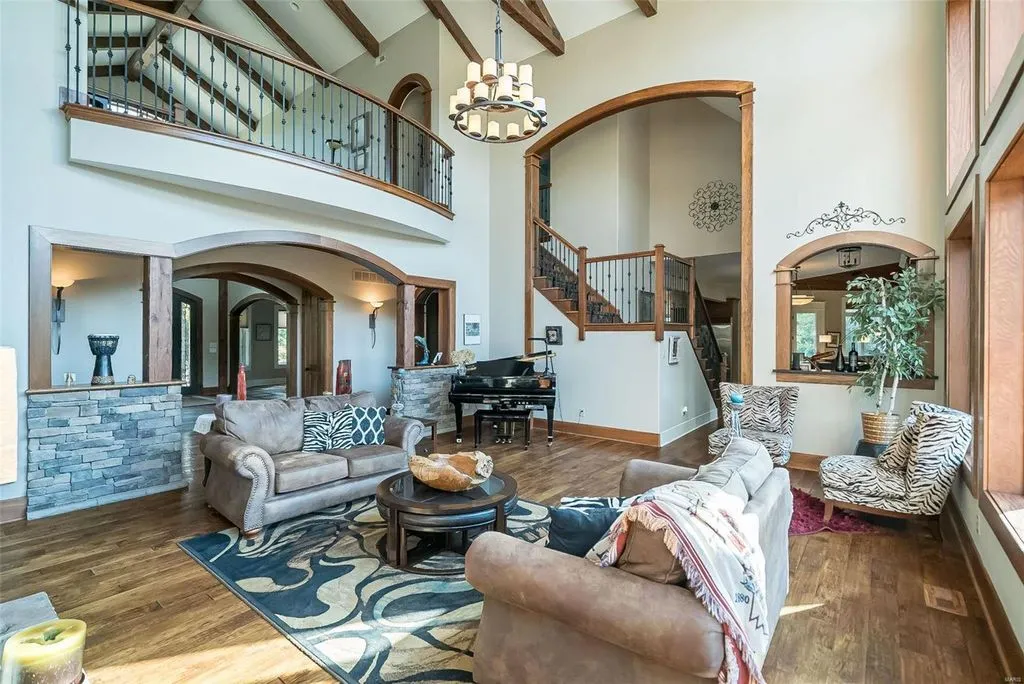 1377 South Mason Road Home in Saint Louis, Missouri. Discover this remarkable 3.3-acre estate bordering Queeny Park, boasting an array of extraordinary outdoor amenities and unmatched privacy. With a massive 2-story foyer, designer kitchen, primary suite with a see-through fireplace, and a sprawling lower level featuring a rec room, theatre, gym, and more. 