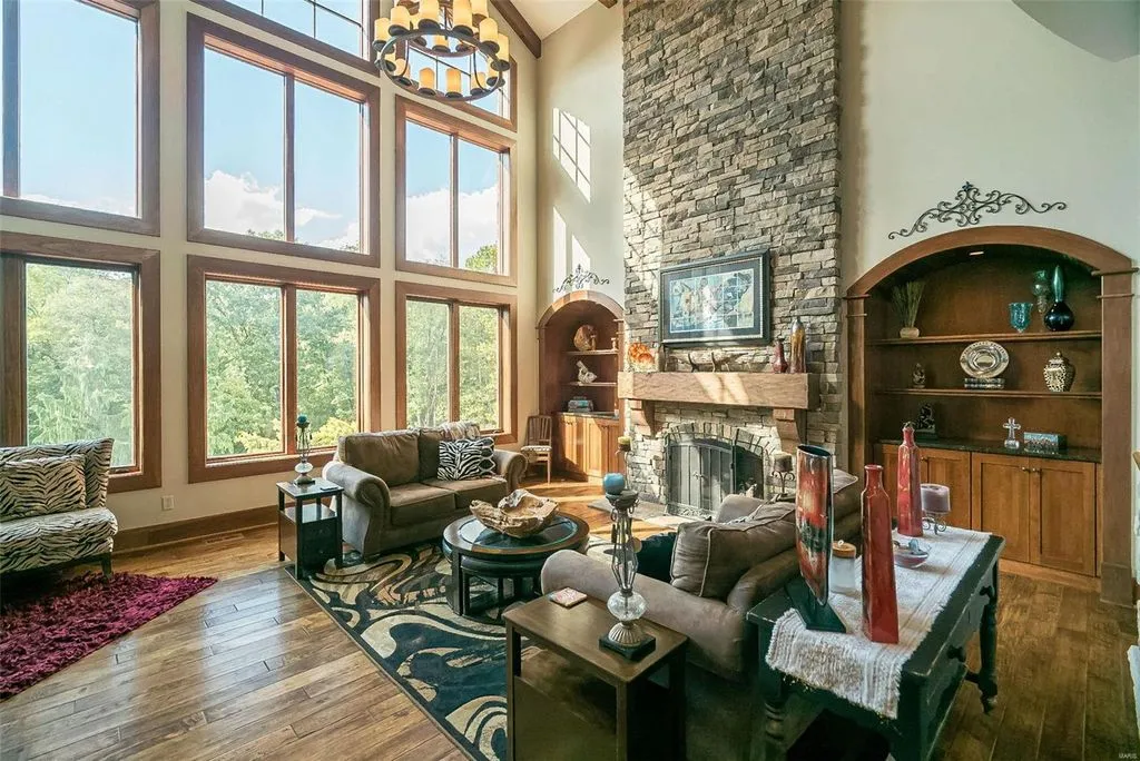 1377 South Mason Road Home in Saint Louis, Missouri. Discover this remarkable 3.3-acre estate bordering Queeny Park, boasting an array of extraordinary outdoor amenities and unmatched privacy. With a massive 2-story foyer, designer kitchen, primary suite with a see-through fireplace, and a sprawling lower level featuring a rec room, theatre, gym, and more. 