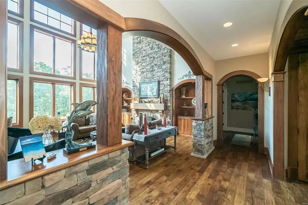 1377 South Mason Road Home in Saint Louis, Missouri. Discover this remarkable 3.3-acre estate bordering Queeny Park, boasting an array of extraordinary outdoor amenities and unmatched privacy. With a massive 2-story foyer, designer kitchen, primary suite with a see-through fireplace, and a sprawling lower level featuring a rec room, theatre, gym, and more. 