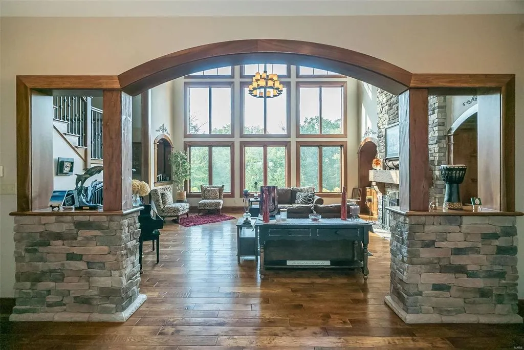 1377 South Mason Road Home in Saint Louis, Missouri. Discover this remarkable 3.3-acre estate bordering Queeny Park, boasting an array of extraordinary outdoor amenities and unmatched privacy. With a massive 2-story foyer, designer kitchen, primary suite with a see-through fireplace, and a sprawling lower level featuring a rec room, theatre, gym, and more. 
