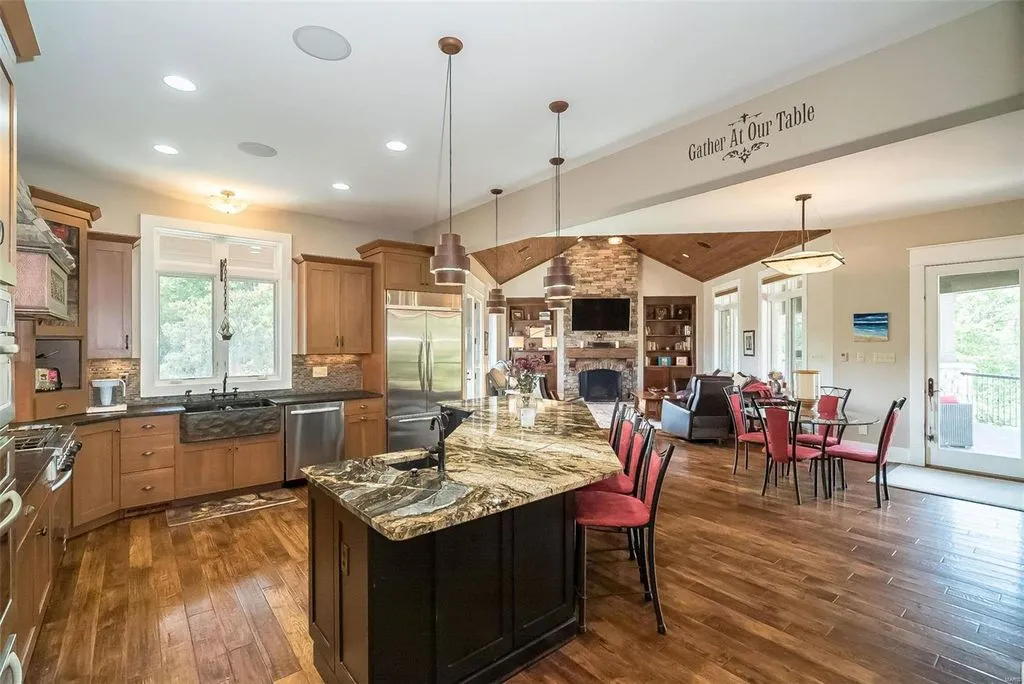 1377 South Mason Road Home in Saint Louis, Missouri. Discover this remarkable 3.3-acre estate bordering Queeny Park, boasting an array of extraordinary outdoor amenities and unmatched privacy. With a massive 2-story foyer, designer kitchen, primary suite with a see-through fireplace, and a sprawling lower level featuring a rec room, theatre, gym, and more. 