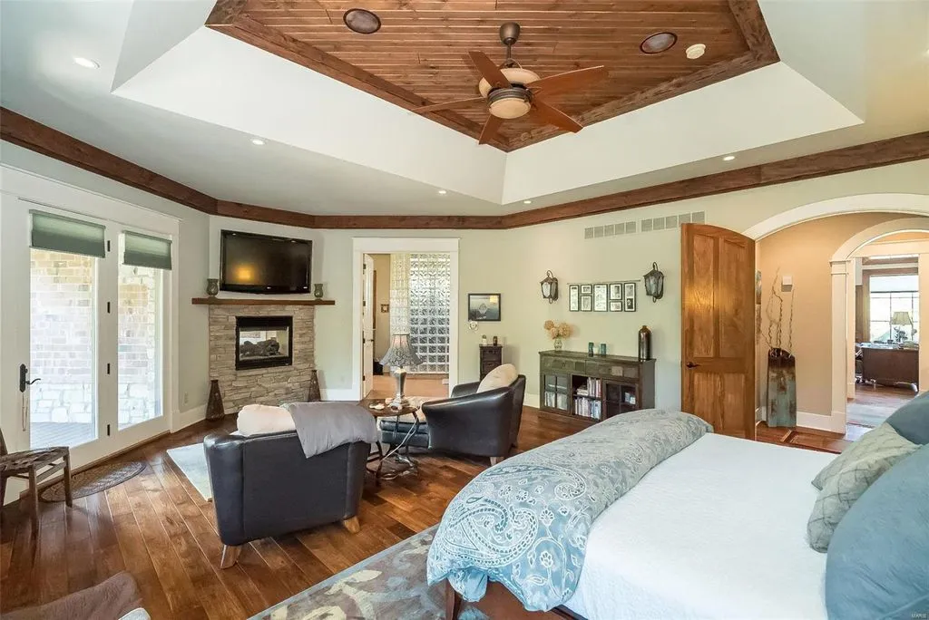 1377 South Mason Road Home in Saint Louis, Missouri. Discover this remarkable 3.3-acre estate bordering Queeny Park, boasting an array of extraordinary outdoor amenities and unmatched privacy. With a massive 2-story foyer, designer kitchen, primary suite with a see-through fireplace, and a sprawling lower level featuring a rec room, theatre, gym, and more. 