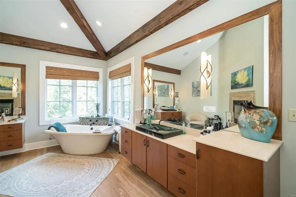 1377 South Mason Road Home in Saint Louis, Missouri. Discover this remarkable 3.3-acre estate bordering Queeny Park, boasting an array of extraordinary outdoor amenities and unmatched privacy. With a massive 2-story foyer, designer kitchen, primary suite with a see-through fireplace, and a sprawling lower level featuring a rec room, theatre, gym, and more. 