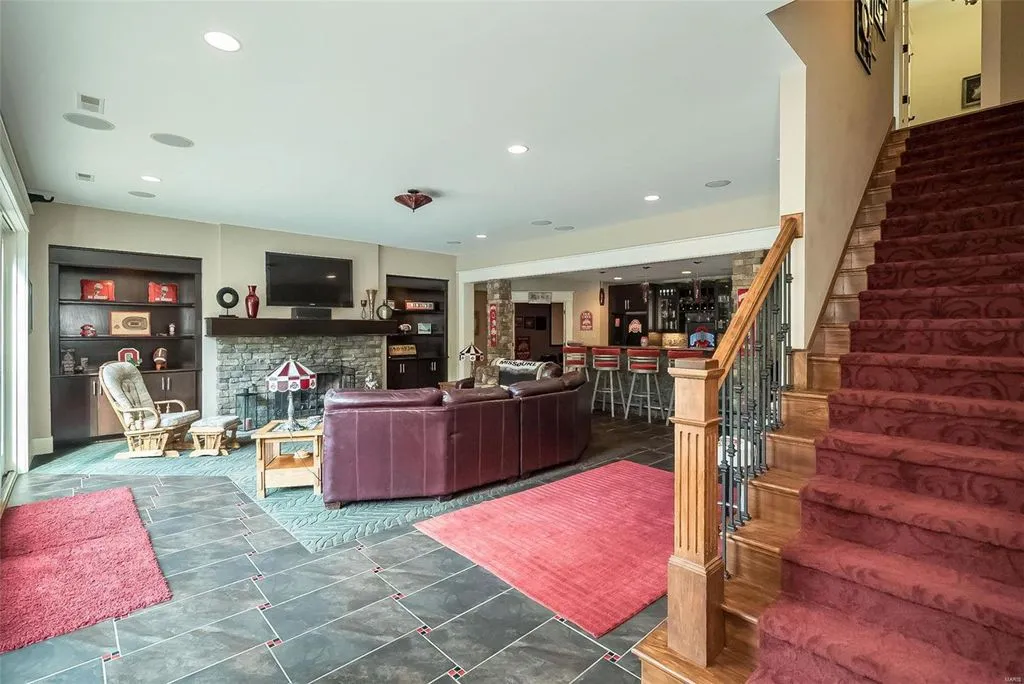 1377 South Mason Road Home in Saint Louis, Missouri. Discover this remarkable 3.3-acre estate bordering Queeny Park, boasting an array of extraordinary outdoor amenities and unmatched privacy. With a massive 2-story foyer, designer kitchen, primary suite with a see-through fireplace, and a sprawling lower level featuring a rec room, theatre, gym, and more. 