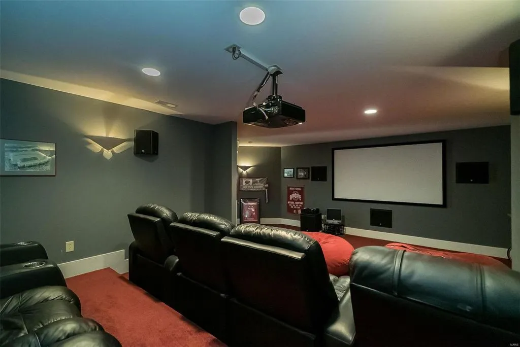 1377 South Mason Road Home in Saint Louis, Missouri. Discover this remarkable 3.3-acre estate bordering Queeny Park, boasting an array of extraordinary outdoor amenities and unmatched privacy. With a massive 2-story foyer, designer kitchen, primary suite with a see-through fireplace, and a sprawling lower level featuring a rec room, theatre, gym, and more. 