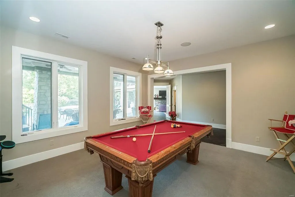 1377 South Mason Road Home in Saint Louis, Missouri. Discover this remarkable 3.3-acre estate bordering Queeny Park, boasting an array of extraordinary outdoor amenities and unmatched privacy. With a massive 2-story foyer, designer kitchen, primary suite with a see-through fireplace, and a sprawling lower level featuring a rec room, theatre, gym, and more. 