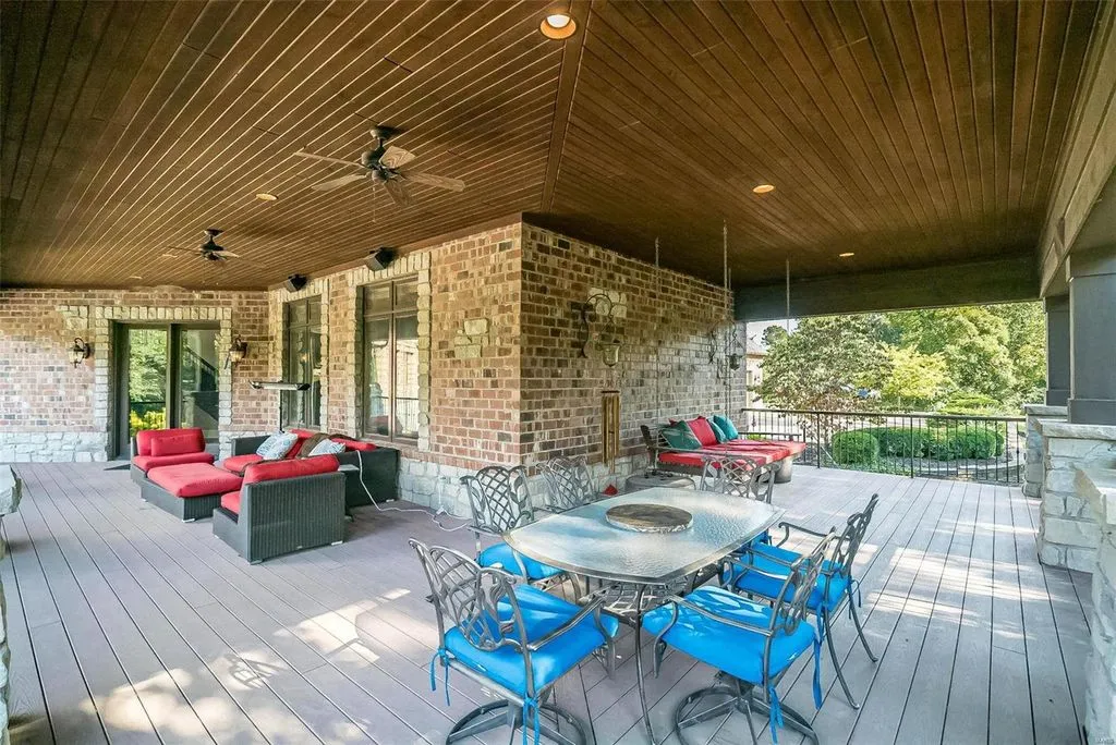 1377 South Mason Road Home in Saint Louis, Missouri. Discover this remarkable 3.3-acre estate bordering Queeny Park, boasting an array of extraordinary outdoor amenities and unmatched privacy. With a massive 2-story foyer, designer kitchen, primary suite with a see-through fireplace, and a sprawling lower level featuring a rec room, theatre, gym, and more. 