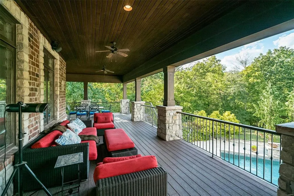 1377 South Mason Road Home in Saint Louis, Missouri. Discover this remarkable 3.3-acre estate bordering Queeny Park, boasting an array of extraordinary outdoor amenities and unmatched privacy. With a massive 2-story foyer, designer kitchen, primary suite with a see-through fireplace, and a sprawling lower level featuring a rec room, theatre, gym, and more. 