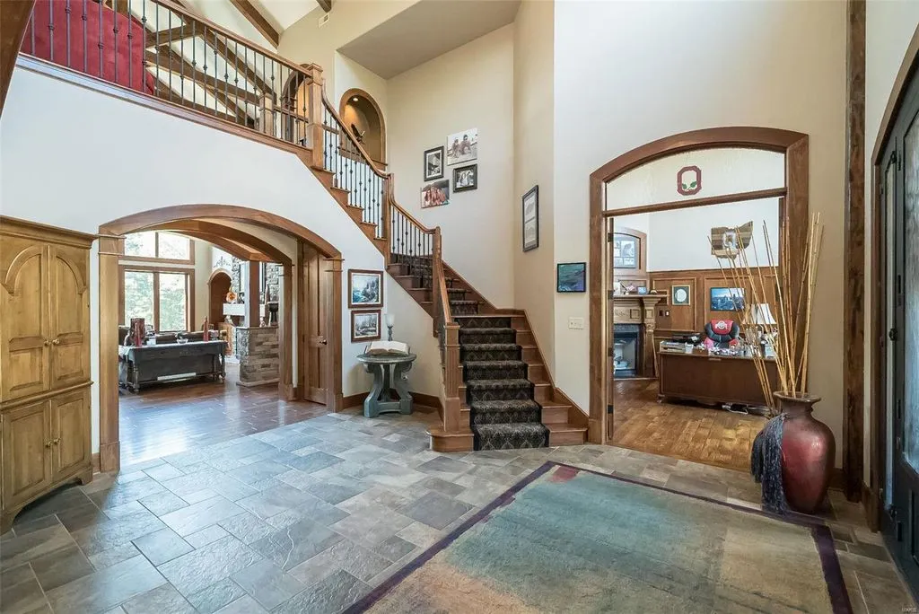 1377 South Mason Road Home in Saint Louis, Missouri. Discover this remarkable 3.3-acre estate bordering Queeny Park, boasting an array of extraordinary outdoor amenities and unmatched privacy. With a massive 2-story foyer, designer kitchen, primary suite with a see-through fireplace, and a sprawling lower level featuring a rec room, theatre, gym, and more. 