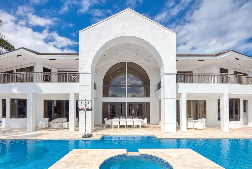 Experience unparalleled luxury in this 7-bedroom, 7-bathroom Golden Beach estate, situated on a 0.41-acre lot with 190 feet of prime waterfront. Renovated to perfection, this contemporary retreat boasts double-height ceilings, a chef's kitchen, a grand master suite, an oversized pool, summer kitchen, and a fully equipped 50-foot dock.