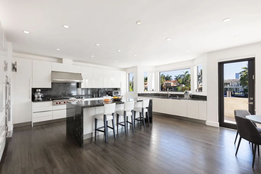 Experience unparalleled luxury in this 7-bedroom, 7-bathroom Golden Beach estate, situated on a 0.41-acre lot with 190 feet of prime waterfront. Renovated to perfection, this contemporary retreat boasts double-height ceilings, a chef's kitchen, a grand master suite, an oversized pool, summer kitchen, and a fully equipped 50-foot dock.