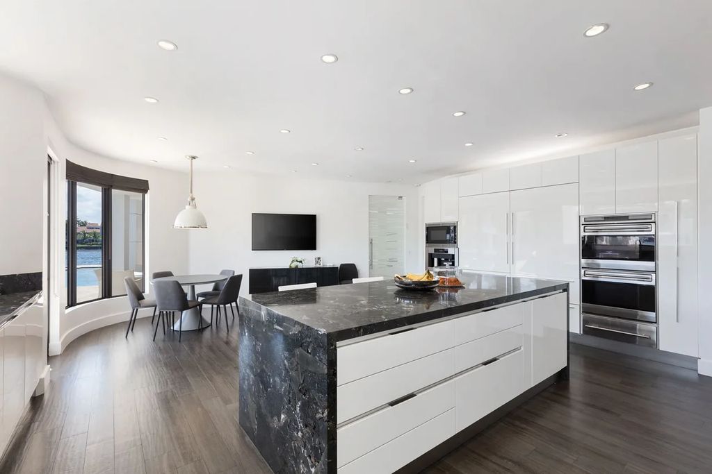 Experience unparalleled luxury in this 7-bedroom, 7-bathroom Golden Beach estate, situated on a 0.41-acre lot with 190 feet of prime waterfront. Renovated to perfection, this contemporary retreat boasts double-height ceilings, a chef's kitchen, a grand master suite, an oversized pool, summer kitchen, and a fully equipped 50-foot dock.
