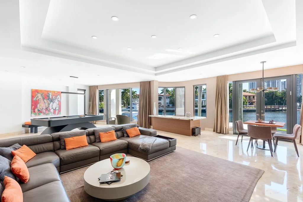 Experience unparalleled luxury in this 7-bedroom, 7-bathroom Golden Beach estate, situated on a 0.41-acre lot with 190 feet of prime waterfront. Renovated to perfection, this contemporary retreat boasts double-height ceilings, a chef's kitchen, a grand master suite, an oversized pool, summer kitchen, and a fully equipped 50-foot dock.