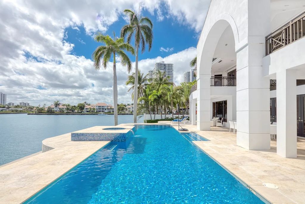 Experience unparalleled luxury in this 7-bedroom, 7-bathroom Golden Beach estate, situated on a 0.41-acre lot with 190 feet of prime waterfront. Renovated to perfection, this contemporary retreat boasts double-height ceilings, a chef's kitchen, a grand master suite, an oversized pool, summer kitchen, and a fully equipped 50-foot dock.