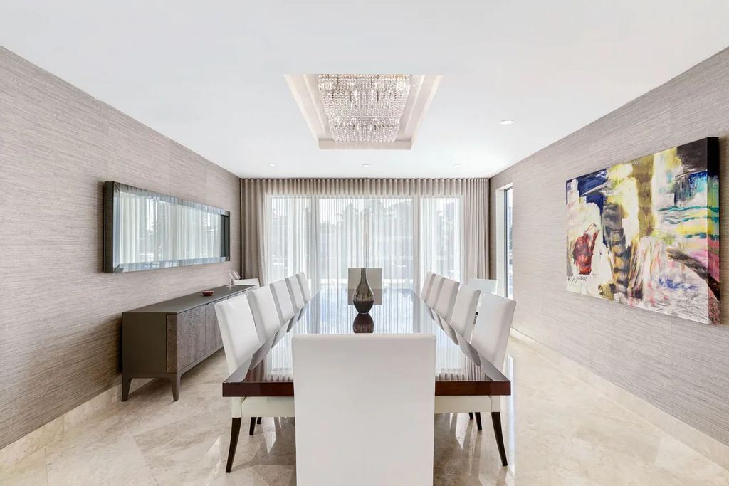 Experience unparalleled luxury in this 7-bedroom, 7-bathroom Golden Beach estate, situated on a 0.41-acre lot with 190 feet of prime waterfront. Renovated to perfection, this contemporary retreat boasts double-height ceilings, a chef's kitchen, a grand master suite, an oversized pool, summer kitchen, and a fully equipped 50-foot dock.