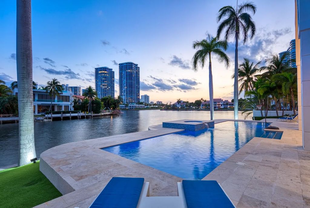 Experience unparalleled luxury in this 7-bedroom, 7-bathroom Golden Beach estate, situated on a 0.41-acre lot with 190 feet of prime waterfront. Renovated to perfection, this contemporary retreat boasts double-height ceilings, a chef's kitchen, a grand master suite, an oversized pool, summer kitchen, and a fully equipped 50-foot dock.