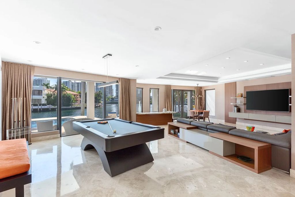 Experience unparalleled luxury in this 7-bedroom, 7-bathroom Golden Beach estate, situated on a 0.41-acre lot with 190 feet of prime waterfront. Renovated to perfection, this contemporary retreat boasts double-height ceilings, a chef's kitchen, a grand master suite, an oversized pool, summer kitchen, and a fully equipped 50-foot dock.