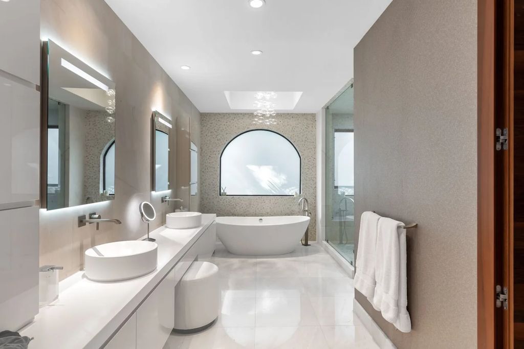 Experience unparalleled luxury in this 7-bedroom, 7-bathroom Golden Beach estate, situated on a 0.41-acre lot with 190 feet of prime waterfront. Renovated to perfection, this contemporary retreat boasts double-height ceilings, a chef's kitchen, a grand master suite, an oversized pool, summer kitchen, and a fully equipped 50-foot dock.