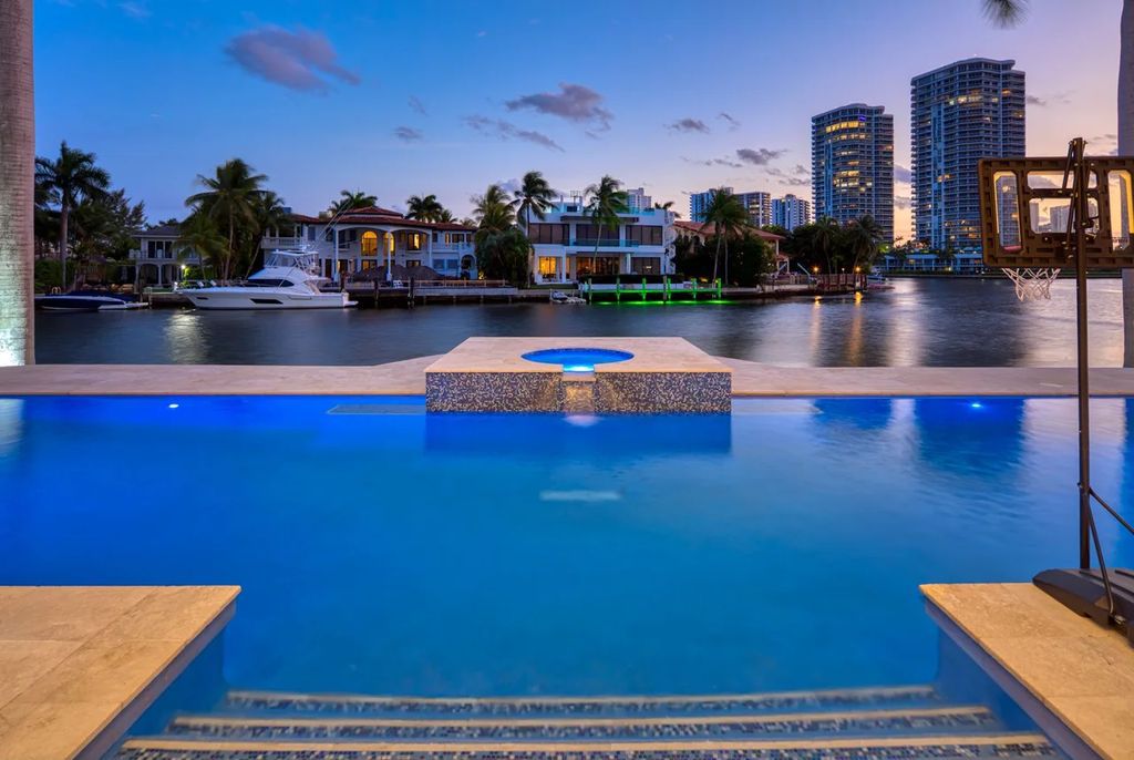 Experience unparalleled luxury in this 7-bedroom, 7-bathroom Golden Beach estate, situated on a 0.41-acre lot with 190 feet of prime waterfront. Renovated to perfection, this contemporary retreat boasts double-height ceilings, a chef's kitchen, a grand master suite, an oversized pool, summer kitchen, and a fully equipped 50-foot dock.