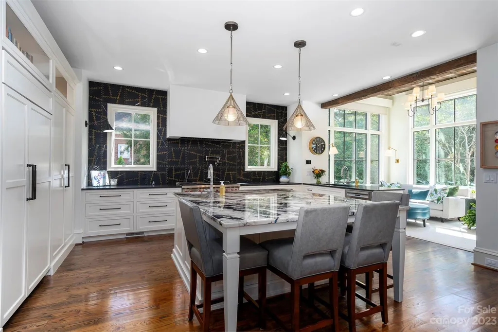 2215 Cortelyou Road Home in Charlotte, North Carolina. Discover the epitome of luxury living in this South Park masterpiece featuring 6 spacious bedrooms, 5 full and 2 half bathrooms, and exquisite craftsmanship throughout. Chef's dream kitchen, a stunning primary suite, media room, sauna, and resort-style outdoor amenities, including a custom pool and outdoor kitchen.