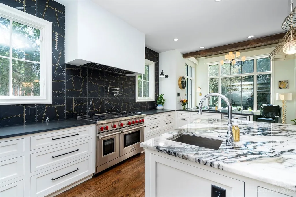 2215 Cortelyou Road Home in Charlotte, North Carolina. Discover the epitome of luxury living in this South Park masterpiece featuring 6 spacious bedrooms, 5 full and 2 half bathrooms, and exquisite craftsmanship throughout. Chef's dream kitchen, a stunning primary suite, media room, sauna, and resort-style outdoor amenities, including a custom pool and outdoor kitchen.