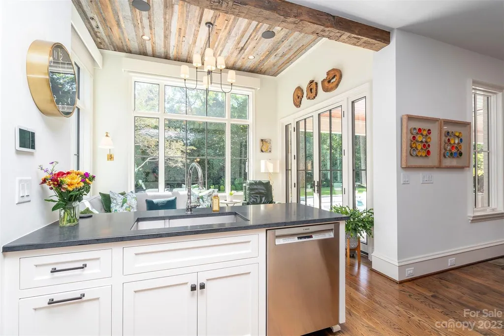 2215 Cortelyou Road Home in Charlotte, North Carolina. Discover the epitome of luxury living in this South Park masterpiece featuring 6 spacious bedrooms, 5 full and 2 half bathrooms, and exquisite craftsmanship throughout. Chef's dream kitchen, a stunning primary suite, media room, sauna, and resort-style outdoor amenities, including a custom pool and outdoor kitchen.