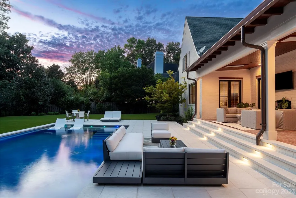 2215 Cortelyou Road Home in Charlotte, North Carolina. Discover the epitome of luxury living in this South Park masterpiece featuring 6 spacious bedrooms, 5 full and 2 half bathrooms, and exquisite craftsmanship throughout. Chef's dream kitchen, a stunning primary suite, media room, sauna, and resort-style outdoor amenities, including a custom pool and outdoor kitchen.
