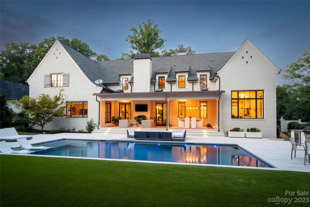 2215 Cortelyou Road Home in Charlotte, North Carolina. Discover the epitome of luxury living in this South Park masterpiece featuring 6 spacious bedrooms, 5 full and 2 half bathrooms, and exquisite craftsmanship throughout. Chef's dream kitchen, a stunning primary suite, media room, sauna, and resort-style outdoor amenities, including a custom pool and outdoor kitchen.