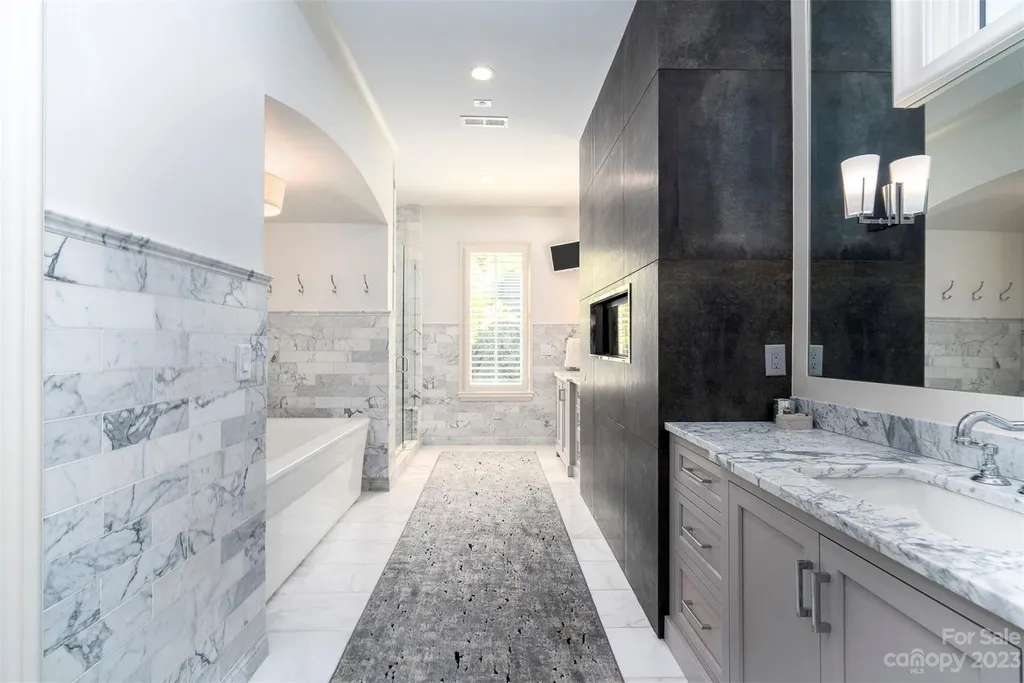 2215 Cortelyou Road Home in Charlotte, North Carolina. Discover the epitome of luxury living in this South Park masterpiece featuring 6 spacious bedrooms, 5 full and 2 half bathrooms, and exquisite craftsmanship throughout. Chef's dream kitchen, a stunning primary suite, media room, sauna, and resort-style outdoor amenities, including a custom pool and outdoor kitchen.