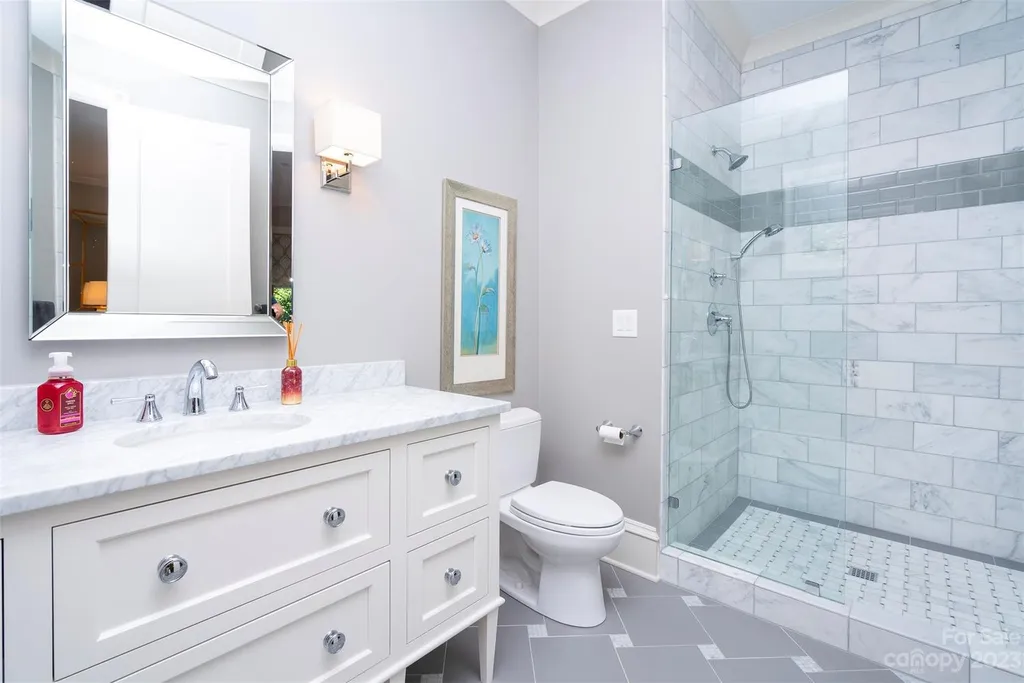 2215 Cortelyou Road Home in Charlotte, North Carolina. Discover the epitome of luxury living in this South Park masterpiece featuring 6 spacious bedrooms, 5 full and 2 half bathrooms, and exquisite craftsmanship throughout. Chef's dream kitchen, a stunning primary suite, media room, sauna, and resort-style outdoor amenities, including a custom pool and outdoor kitchen.