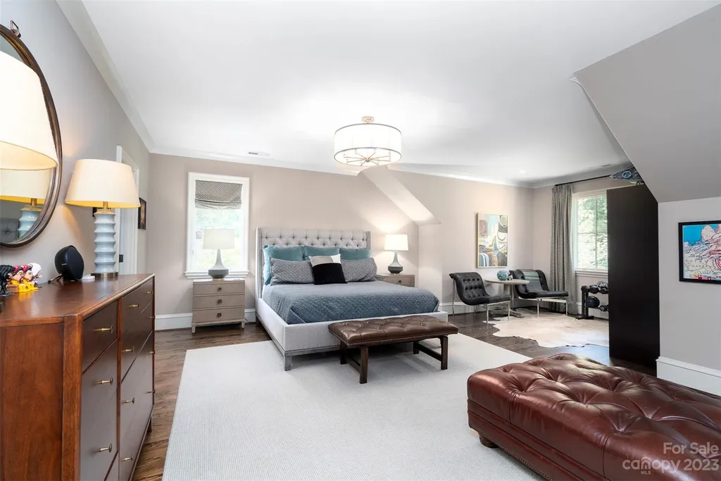 2215 Cortelyou Road Home in Charlotte, North Carolina. Discover the epitome of luxury living in this South Park masterpiece featuring 6 spacious bedrooms, 5 full and 2 half bathrooms, and exquisite craftsmanship throughout. Chef's dream kitchen, a stunning primary suite, media room, sauna, and resort-style outdoor amenities, including a custom pool and outdoor kitchen.
