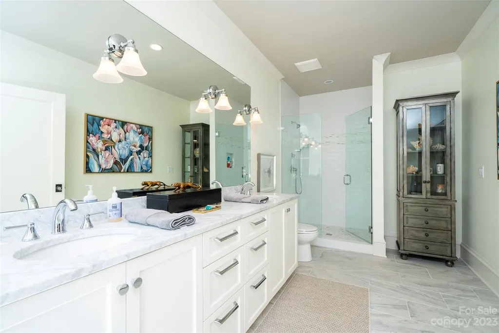2215 Cortelyou Road Home in Charlotte, North Carolina. Discover the epitome of luxury living in this South Park masterpiece featuring 6 spacious bedrooms, 5 full and 2 half bathrooms, and exquisite craftsmanship throughout. Chef's dream kitchen, a stunning primary suite, media room, sauna, and resort-style outdoor amenities, including a custom pool and outdoor kitchen.
