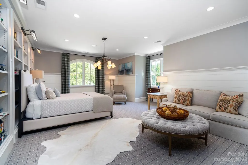 2215 Cortelyou Road Home in Charlotte, North Carolina. Discover the epitome of luxury living in this South Park masterpiece featuring 6 spacious bedrooms, 5 full and 2 half bathrooms, and exquisite craftsmanship throughout. Chef's dream kitchen, a stunning primary suite, media room, sauna, and resort-style outdoor amenities, including a custom pool and outdoor kitchen.