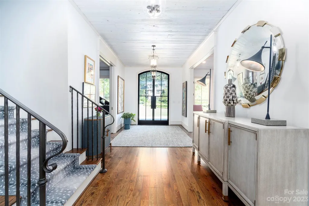2215 Cortelyou Road Home in Charlotte, North Carolina. Discover the epitome of luxury living in this South Park masterpiece featuring 6 spacious bedrooms, 5 full and 2 half bathrooms, and exquisite craftsmanship throughout. Chef's dream kitchen, a stunning primary suite, media room, sauna, and resort-style outdoor amenities, including a custom pool and outdoor kitchen.