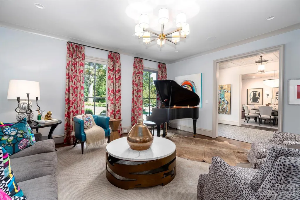 2215 Cortelyou Road Home in Charlotte, North Carolina. Discover the epitome of luxury living in this South Park masterpiece featuring 6 spacious bedrooms, 5 full and 2 half bathrooms, and exquisite craftsmanship throughout. Chef's dream kitchen, a stunning primary suite, media room, sauna, and resort-style outdoor amenities, including a custom pool and outdoor kitchen.