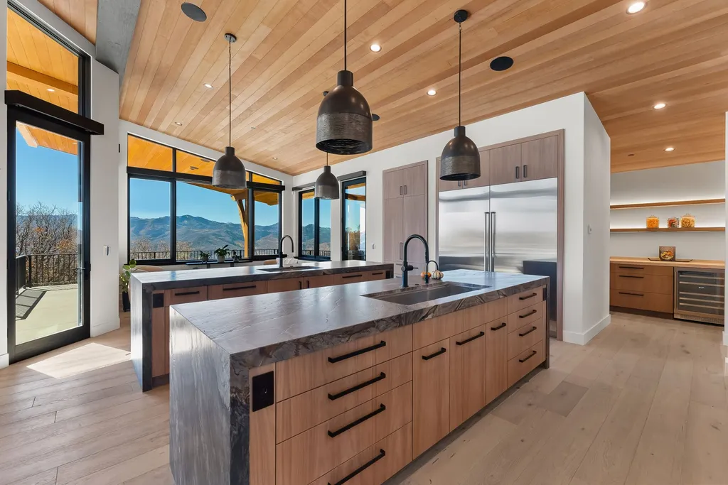 2409 Preserve Drive Home in Park City, Utah. Discover this stunning 6-bedroom, 8-bathroom, 9,196 sq. ft. contemporary home in The Preserve, a premier gated community. Perched on 9.07 acres at the mountain's summit, the home offers breathtaking 280-degree views of ski areas, the Olympic Park, and Salt Lake City.