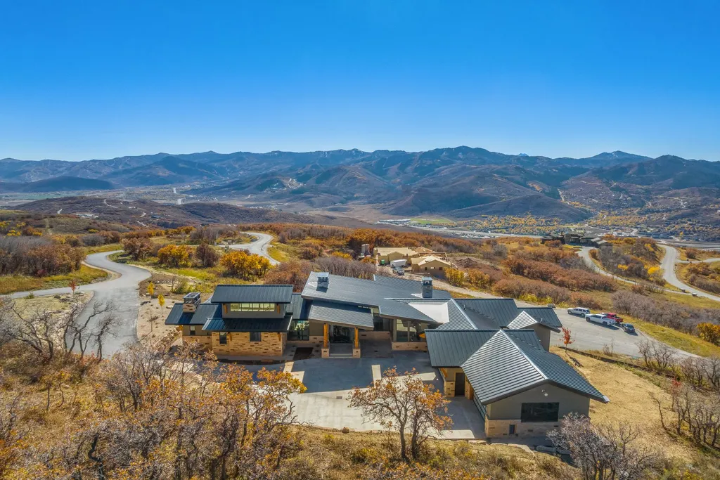 2409 Preserve Drive Home in Park City, Utah. Discover this stunning 6-bedroom, 8-bathroom, 9,196 sq. ft. contemporary home in The Preserve, a premier gated community. Perched on 9.07 acres at the mountain's summit, the home offers breathtaking 280-degree views of ski areas, the Olympic Park, and Salt Lake City.