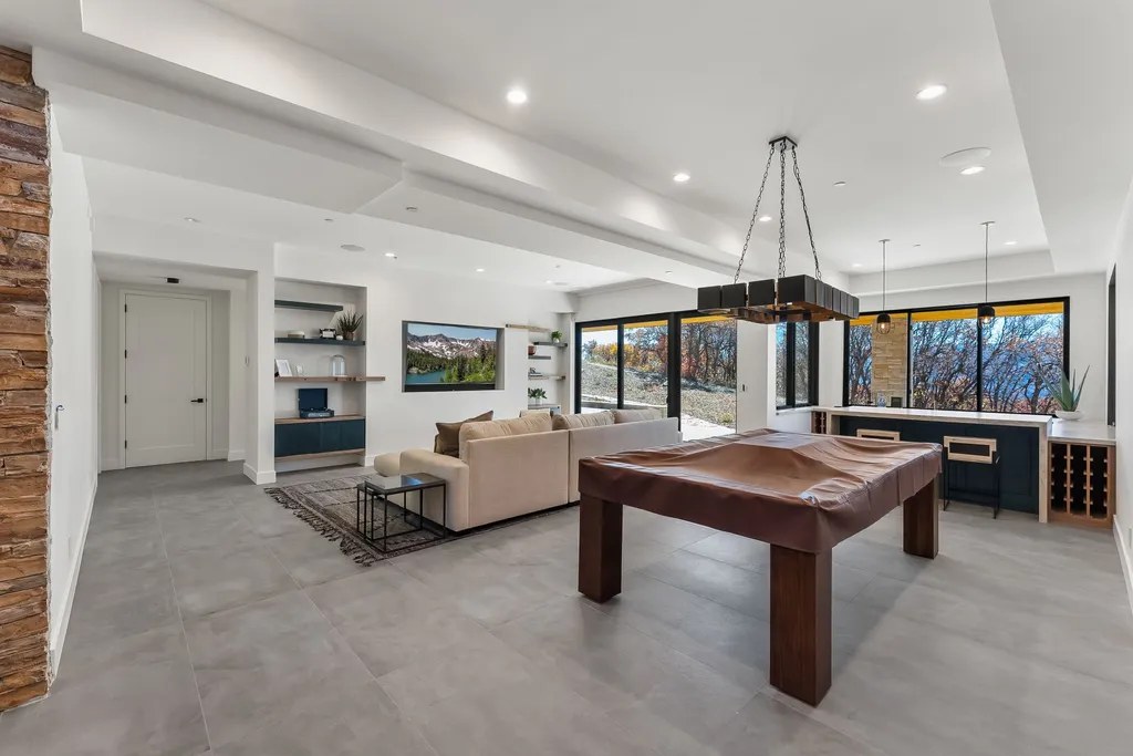 2409 Preserve Drive Home in Park City, Utah. Discover this stunning 6-bedroom, 8-bathroom, 9,196 sq. ft. contemporary home in The Preserve, a premier gated community. Perched on 9.07 acres at the mountain's summit, the home offers breathtaking 280-degree views of ski areas, the Olympic Park, and Salt Lake City.