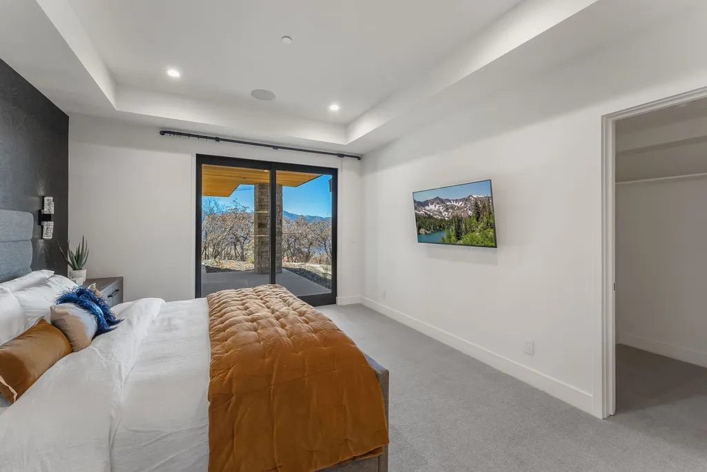 2409 Preserve Drive Home in Park City, Utah. Discover this stunning 6-bedroom, 8-bathroom, 9,196 sq. ft. contemporary home in The Preserve, a premier gated community. Perched on 9.07 acres at the mountain's summit, the home offers breathtaking 280-degree views of ski areas, the Olympic Park, and Salt Lake City.