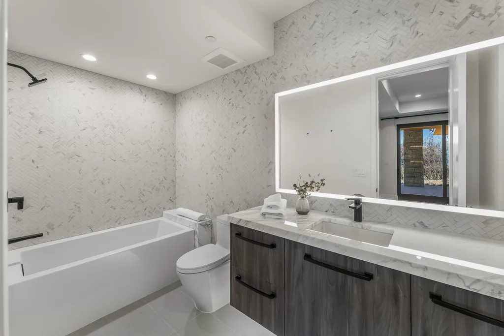 2409 Preserve Drive Home in Park City, Utah. Discover this stunning 6-bedroom, 8-bathroom, 9,196 sq. ft. contemporary home in The Preserve, a premier gated community. Perched on 9.07 acres at the mountain's summit, the home offers breathtaking 280-degree views of ski areas, the Olympic Park, and Salt Lake City.