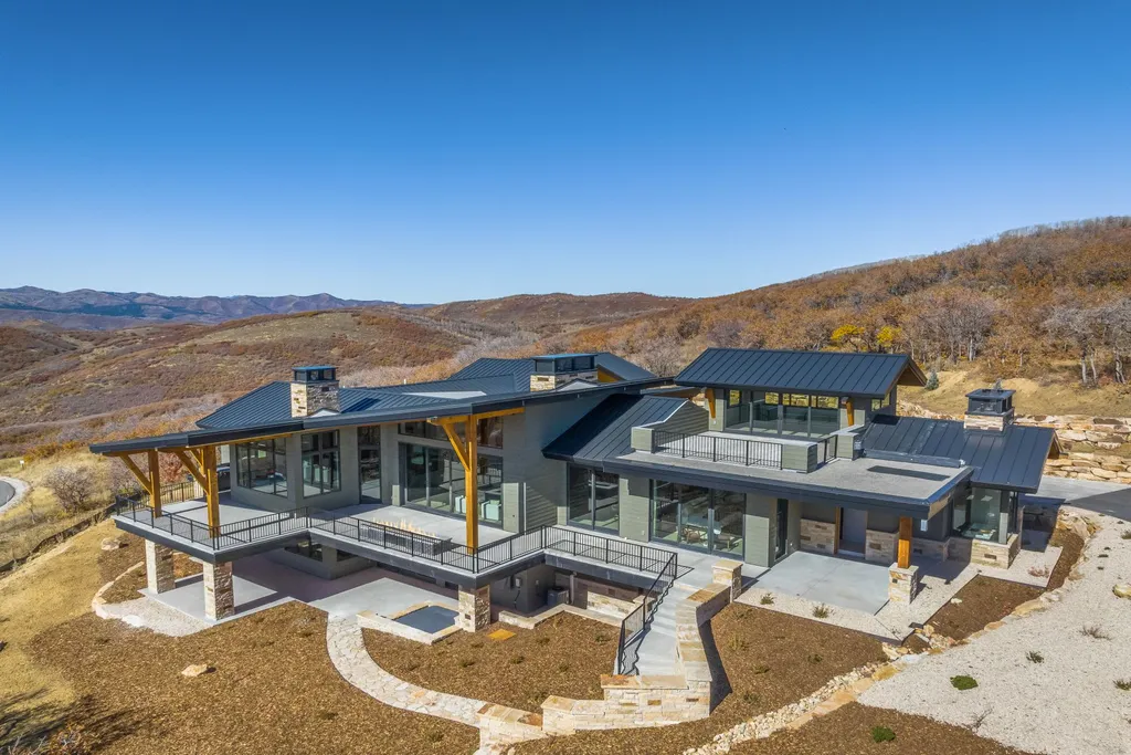 2409 Preserve Drive Home in Park City, Utah. Discover this stunning 6-bedroom, 8-bathroom, 9,196 sq. ft. contemporary home in The Preserve, a premier gated community. Perched on 9.07 acres at the mountain's summit, the home offers breathtaking 280-degree views of ski areas, the Olympic Park, and Salt Lake City.