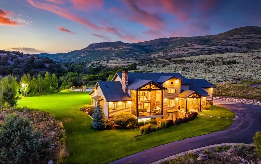4115 Greener Hills Drive Home in Heber, Utah. Discover a 7.55-acre gated estate in Greener Hills. This luxury property features remarkable entertainment amenities, from exposed wood beams to a gourmet kitchen with Wolf appliances, an outdoor kitchen, pool, and firepit. The main level master offers radiant heat flooring, and the estate includes a playhouse, home theater, and more.