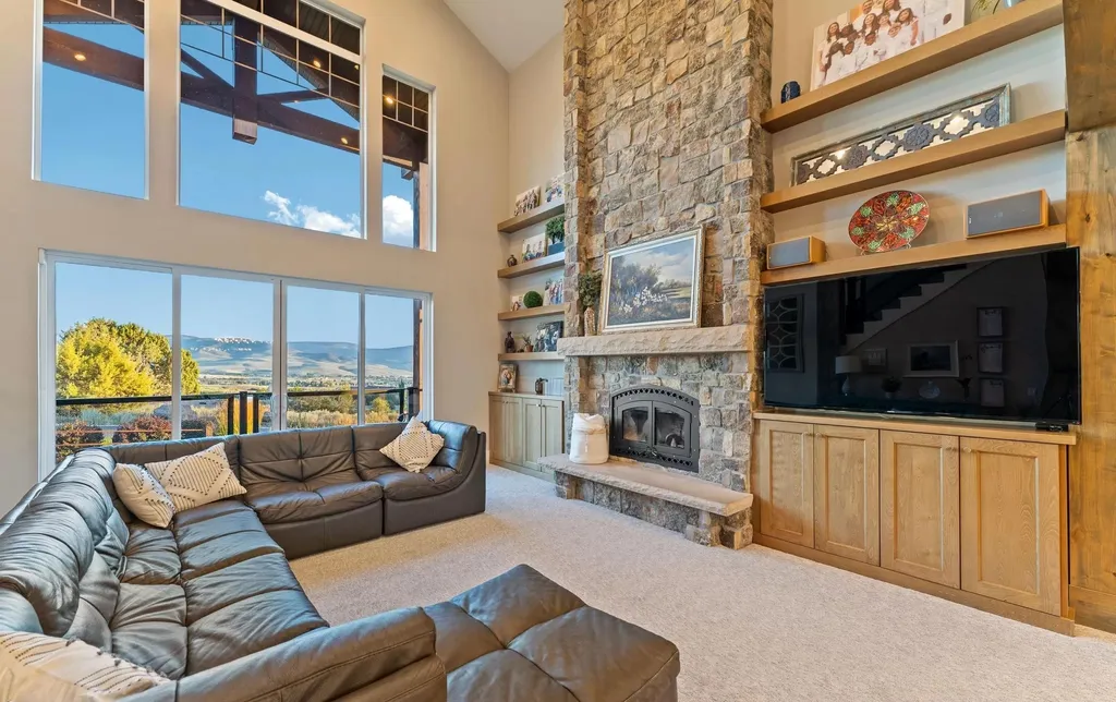 4115 Greener Hills Drive Home in Heber, Utah. Discover a 7.55-acre gated estate in Greener Hills. This luxury property features remarkable entertainment amenities, from exposed wood beams to a gourmet kitchen with Wolf appliances, an outdoor kitchen, pool, and firepit. The main level master offers radiant heat flooring, and the estate includes a playhouse, home theater, and more.