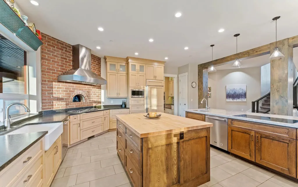 4115 Greener Hills Drive Home in Heber, Utah. Discover a 7.55-acre gated estate in Greener Hills. This luxury property features remarkable entertainment amenities, from exposed wood beams to a gourmet kitchen with Wolf appliances, an outdoor kitchen, pool, and firepit. The main level master offers radiant heat flooring, and the estate includes a playhouse, home theater, and more.