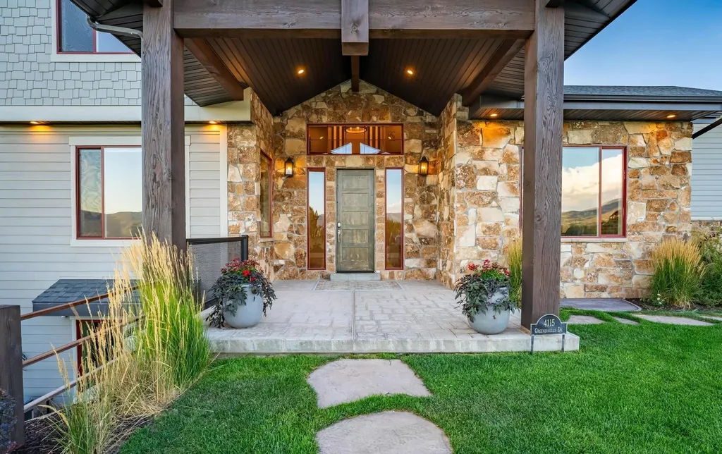 4115 Greener Hills Drive Home in Heber, Utah. Discover a 7.55-acre gated estate in Greener Hills. This luxury property features remarkable entertainment amenities, from exposed wood beams to a gourmet kitchen with Wolf appliances, an outdoor kitchen, pool, and firepit. The main level master offers radiant heat flooring, and the estate includes a playhouse, home theater, and more.