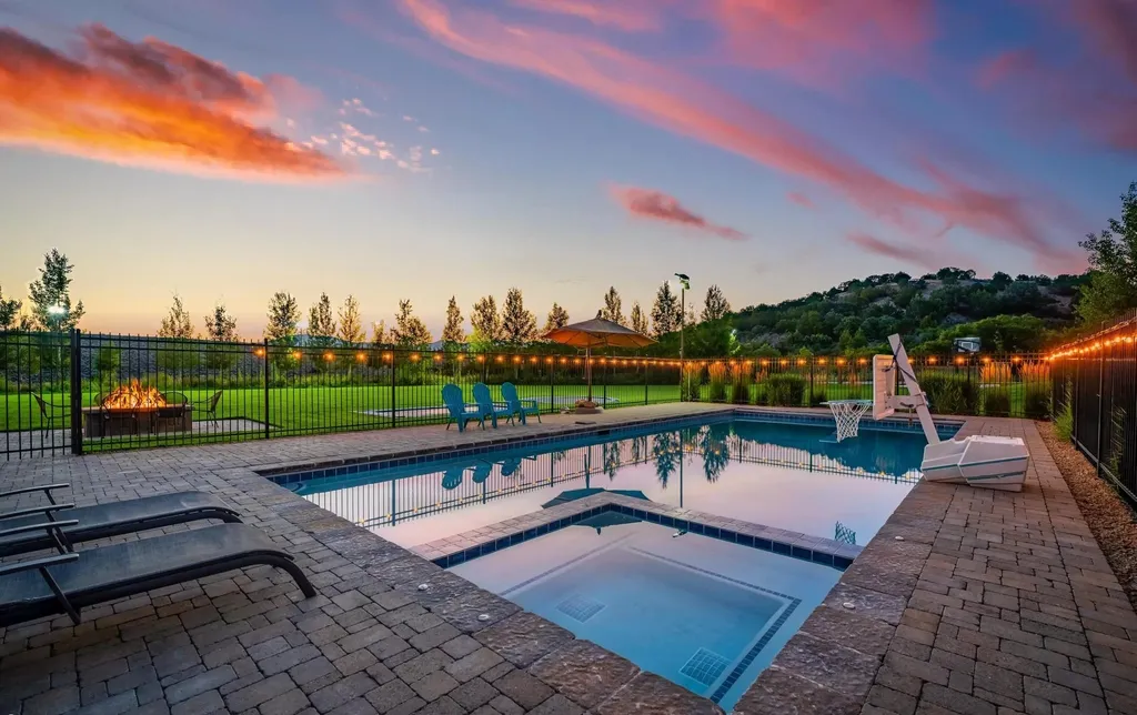 4115 Greener Hills Drive Home in Heber, Utah. Discover a 7.55-acre gated estate in Greener Hills. This luxury property features remarkable entertainment amenities, from exposed wood beams to a gourmet kitchen with Wolf appliances, an outdoor kitchen, pool, and firepit. The main level master offers radiant heat flooring, and the estate includes a playhouse, home theater, and more.