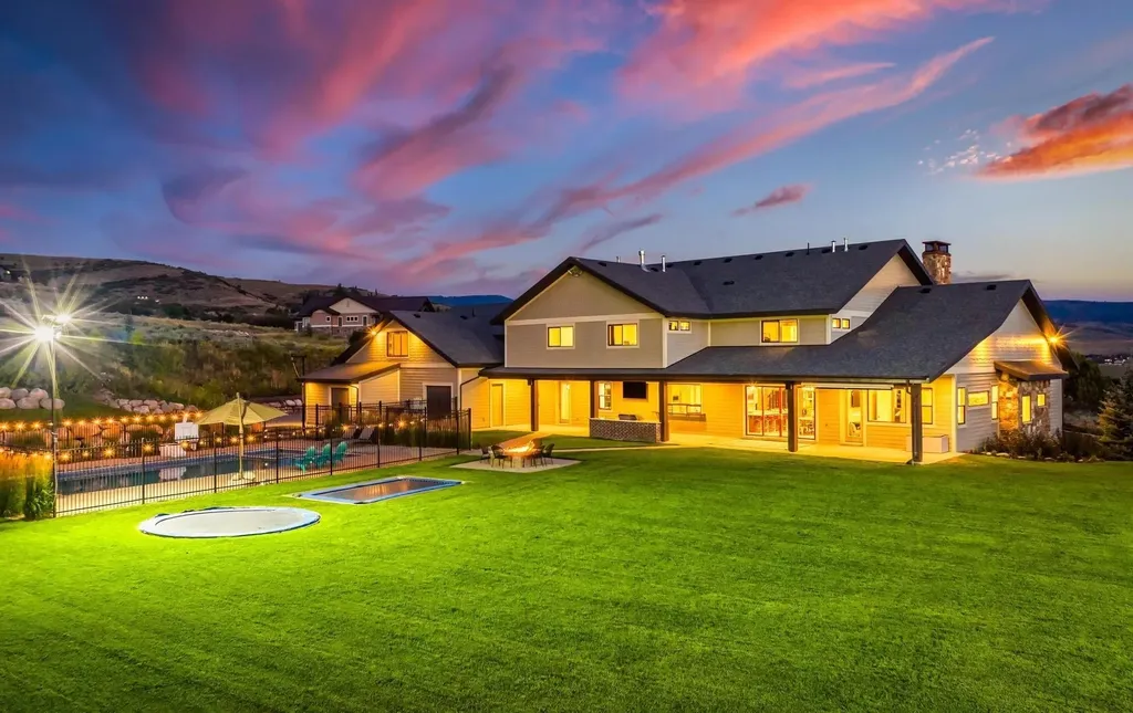4115 Greener Hills Drive Home in Heber, Utah. Discover a 7.55-acre gated estate in Greener Hills. This luxury property features remarkable entertainment amenities, from exposed wood beams to a gourmet kitchen with Wolf appliances, an outdoor kitchen, pool, and firepit. The main level master offers radiant heat flooring, and the estate includes a playhouse, home theater, and more.